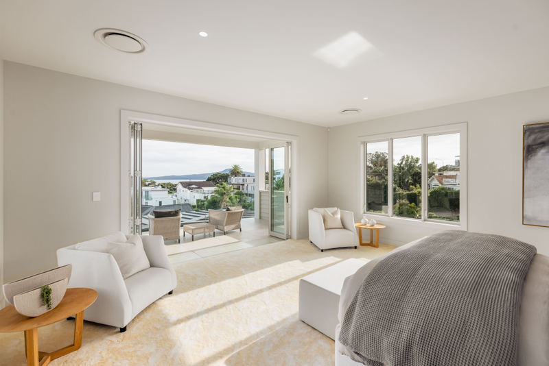 Living room opening to the view, 20 Springcombe Road, St Heliers